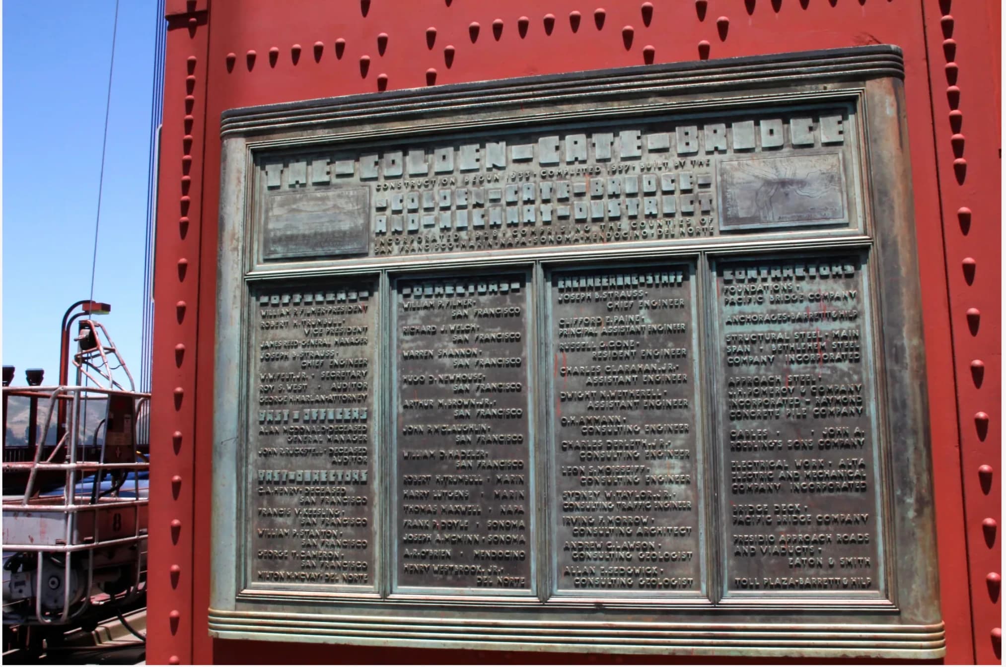 A bronze plaque on the Golden Gate Bridge’s red steel tower names the directors, engineers, and contractors who helped build it.